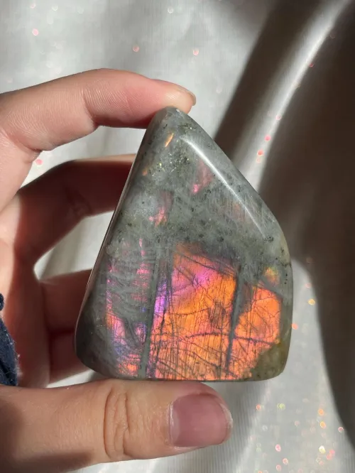 Close-up comparison showing natural vs. synthetic labradorite patterns