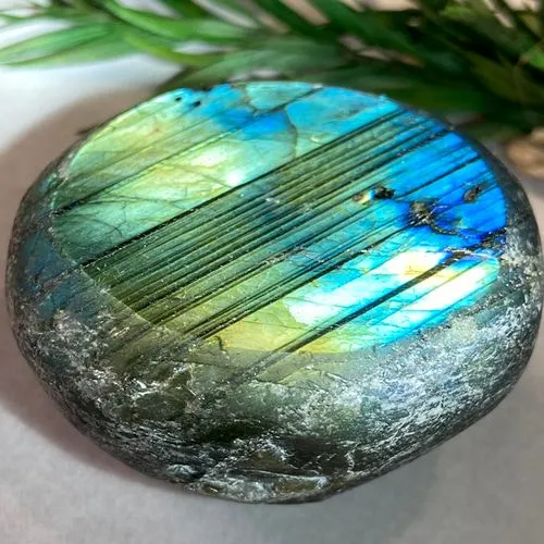 Close-up comparison showing quartz's vitreous luster versus labradorite's cleavage planes