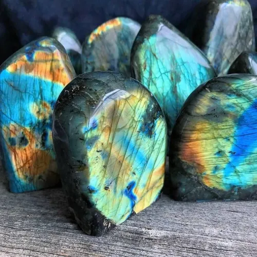 Close-up of labradorite catching light at different angles displaying flashes