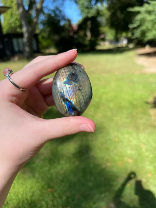 Close-up of various stones paired with labradorite on a surface, showing color combinations