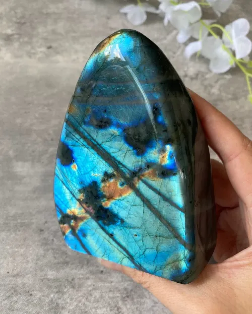 Labradorite jewelry and palm stones in daily use contexts