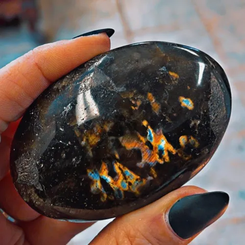 Polished labradorite tile used as a wall accent with blue flashes visible