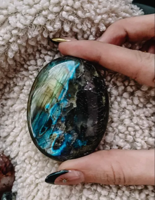 Close-up view of labradorite showing light diffraction and schiller effect from different angles
