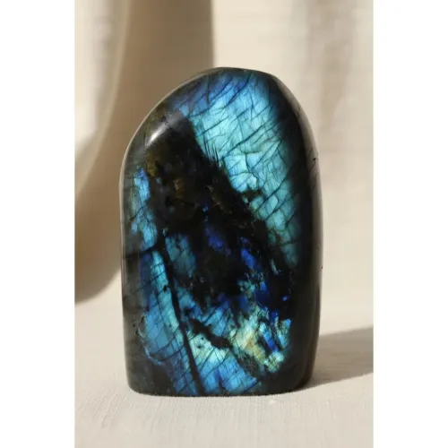 Woman adjusting labradorite bracelet during work break